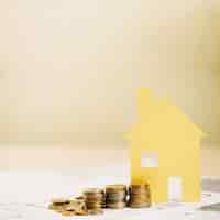 Free photo yellow house figurines and coins