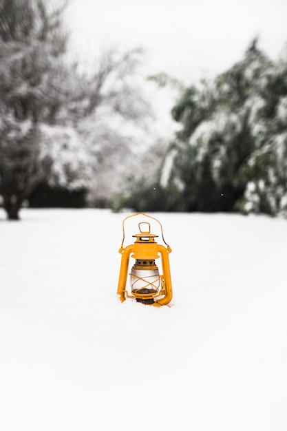 Yellow lantern on snow