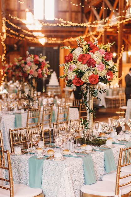 Yellow light garlands hang over the dinner tables decorated