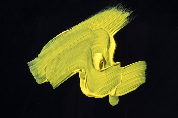 Yellow paint on black background