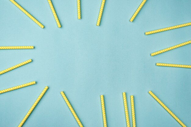 Yellow paper straws flat lay