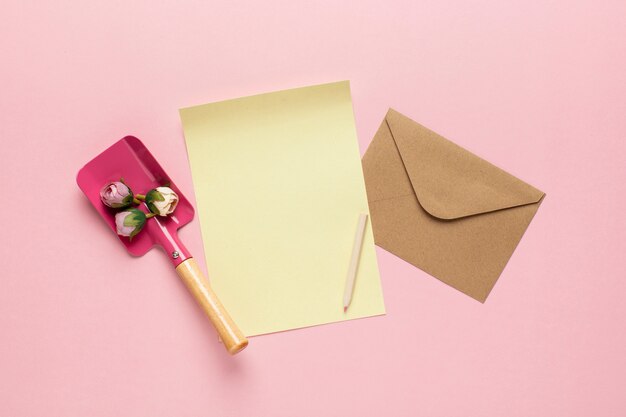 Yellow paper with envelope shovel with flowers