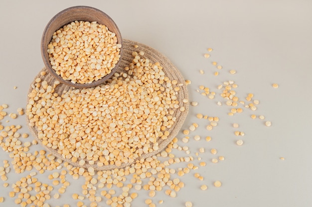 Yellow pea beans on a wooden board on concrete.