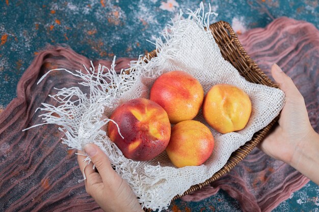 Yellow peaches on a white rustic kitchen towel. 