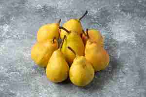 Free photo yellow pears on concrete surface.