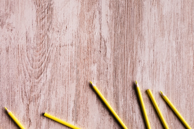 Free photo yellow pencils on wooden surface