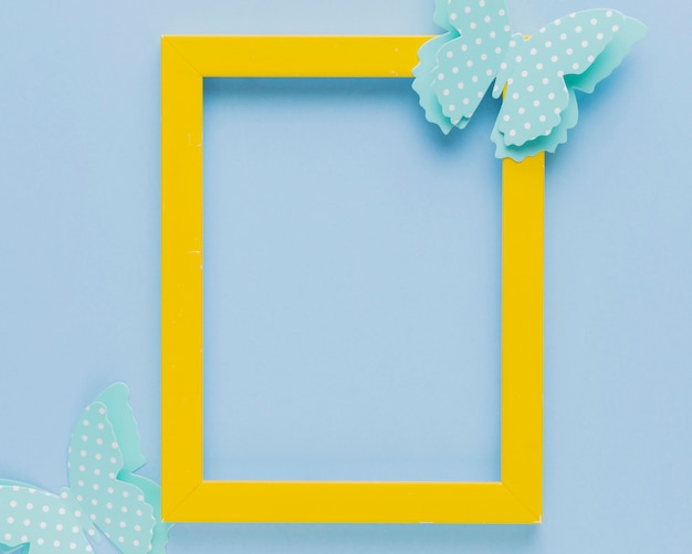 Yellow picture frame decorated with butterfly cutout