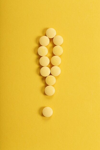 Yellow pills on yellow surface