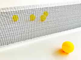 Free photo yellow ping pong ball on a table