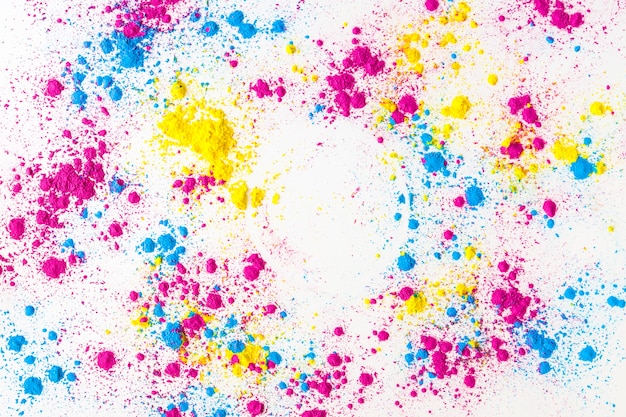 Yellow; pink and blue holi color powder splatter on white background