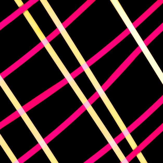 Yellow and pink light grid on black backdrop