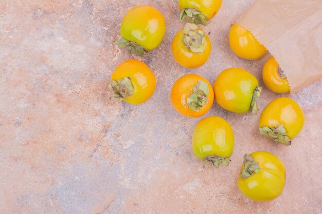 Yellow plum dates isolated on pink.