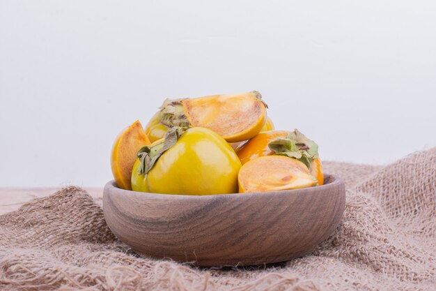 Yellow plum dates in a wooden cup