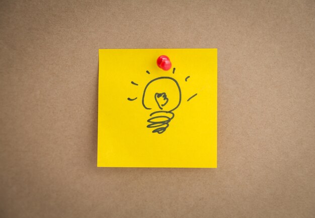 Yellow post-it with a drawn bulb