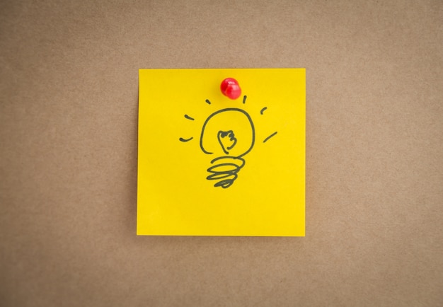Yellow post-it with a drawn bulb