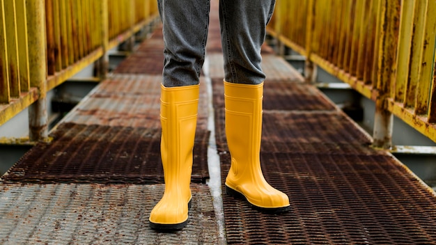 Free photo yellow rain boots on bridge