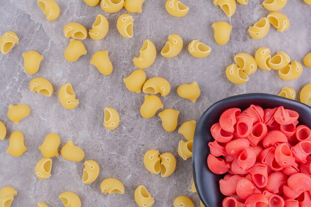 Yellow and red color pastas on the marble surface