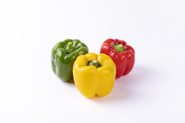 Yellow, red, and green Bulgarian pepper isolated on a white table