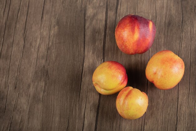 Yellow red peaches on a wooden cutting board. 