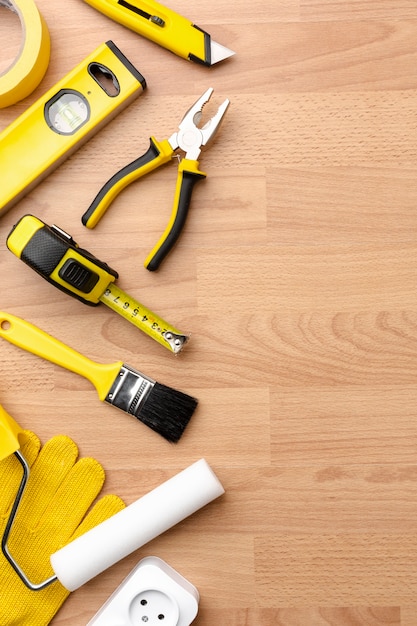 Yellow repair kit on wooden background