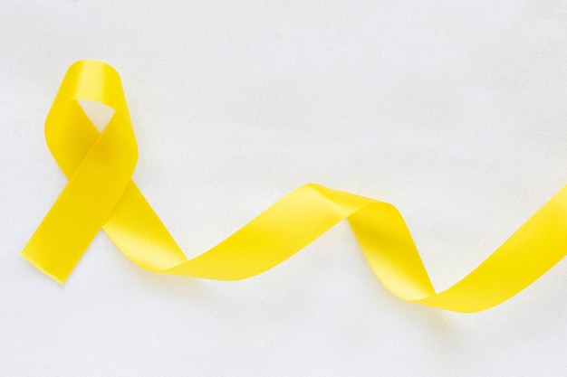 Yellow ribbon. bone cancer, sarcoma awareness, childhood cancer, world suicide prevention.