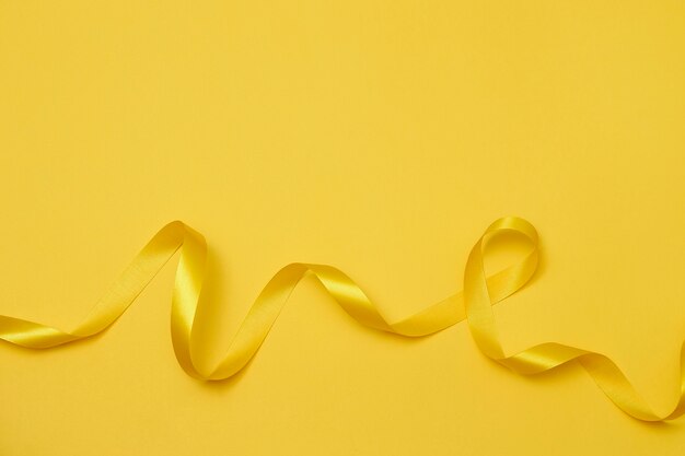 Yellow ribbon on yellowish background