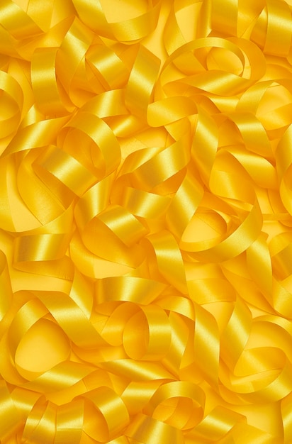 Free photo yellow ribbon on yellowish background