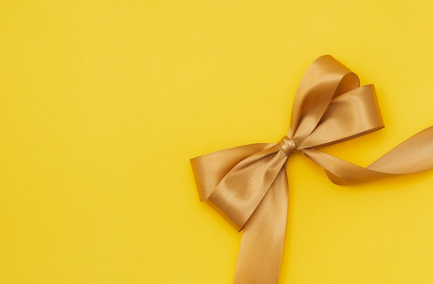 Free photo yellow ribbon on yellowish background