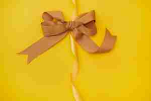 Free photo yellow ribbon on yellowish background