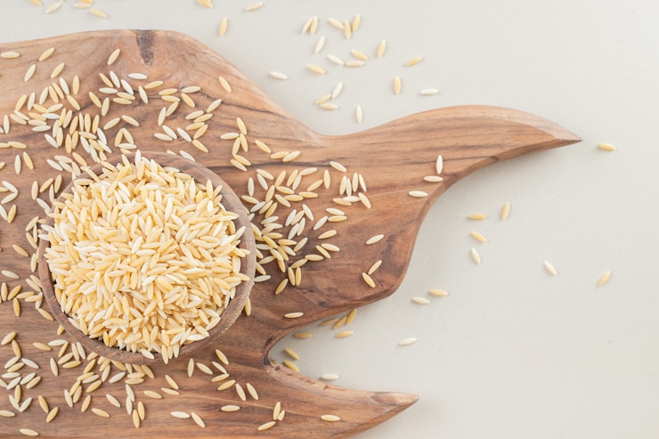 Free Photo yellow rice seeds in food cups on concrete.