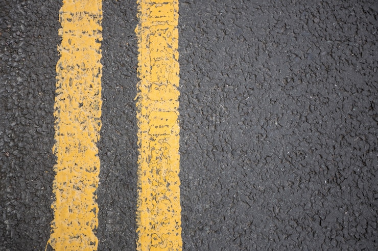 Free Photo yellow road marking on road surface