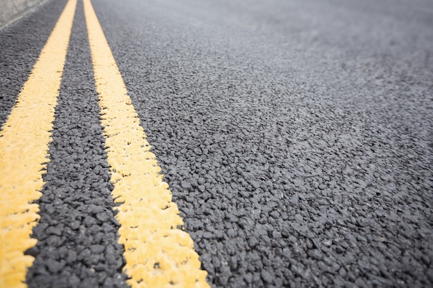 Yellow road marking on road surface