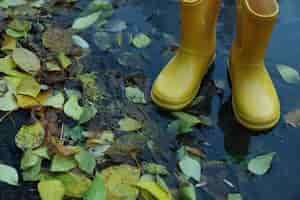 Free photo yellow rubber boots outdoor in rainy weather