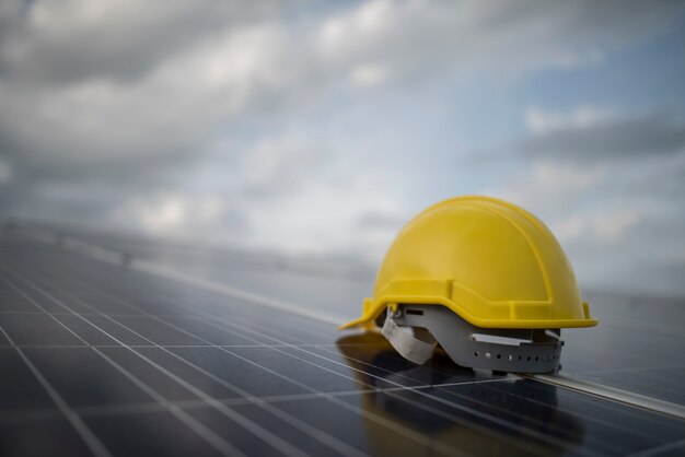 Yellow safety helmet on solar cell panel