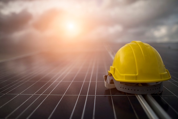 Yellow safety helmet on solar cell panel