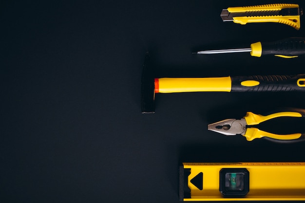 Yellow set of tools on black background