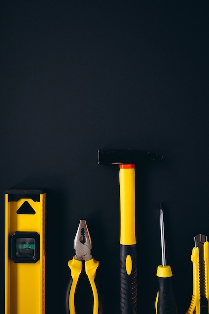 Yellow set of tools on black background