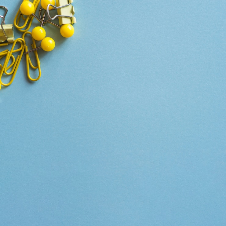 Free Photo yellow and steel stationery on blue table 