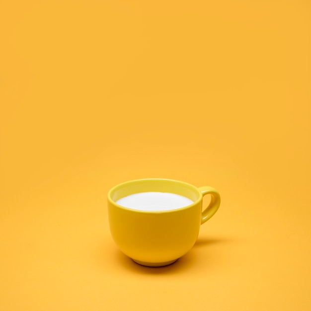 Free photo yellow still life of cup of milk