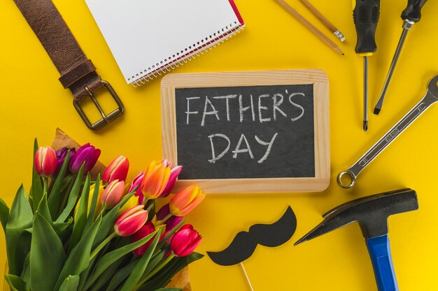 Yellow surface with slate and accessories for father's day