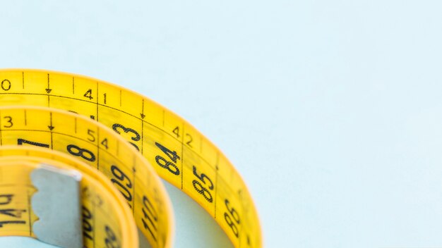 yellow tape measure on blue background