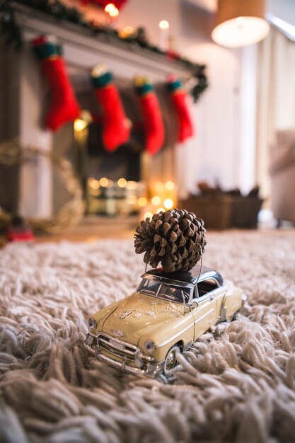 Yellow toy car with a pinecone