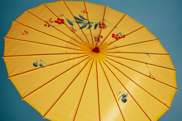 Yellow wagasa umbrella in studio high angle