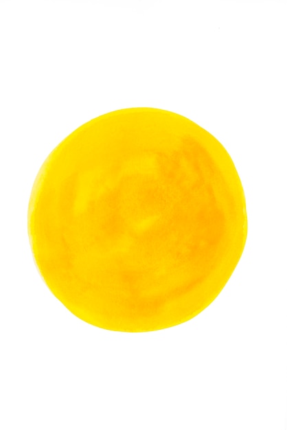 Yellow watercolor circle on white paper