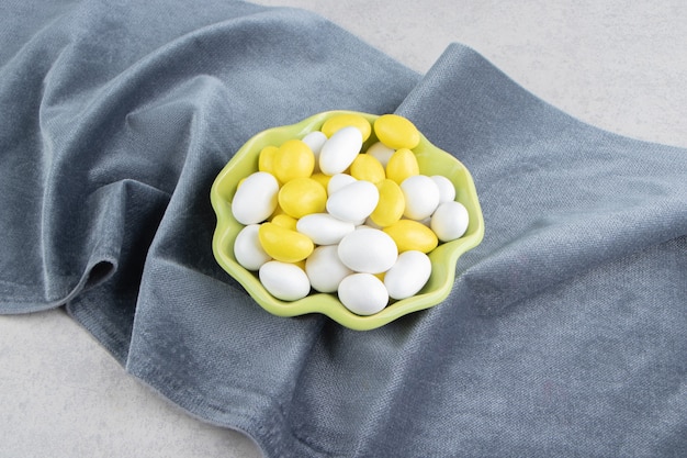 Yellow and white gums on the towel on the marble surface