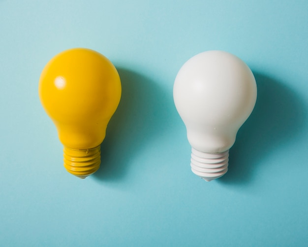 Yellow and white light bulb on blue background