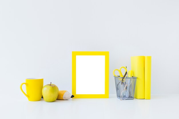 Yellow writing accessories for studies on white workplace