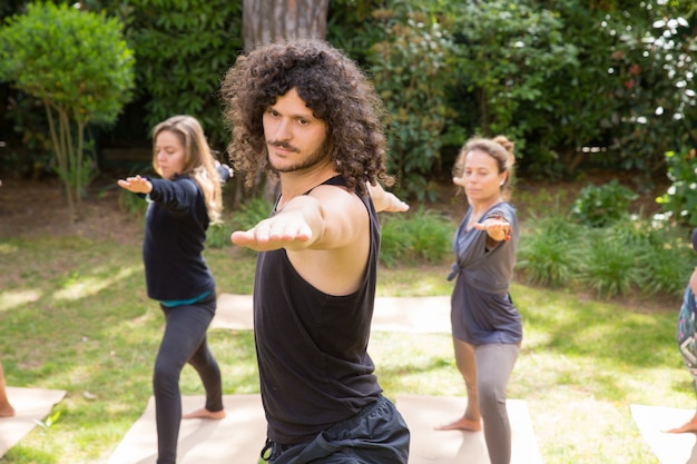 Yoga lovers enjoying training in park