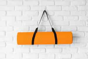 Free photo yoga mat hanging on wall