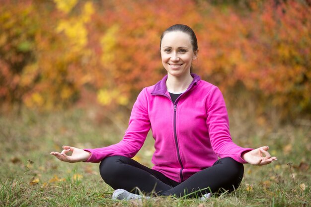 Yoga outdoors: yogi girl meditating